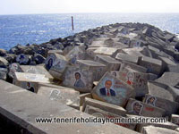 Celebrity images on breakwater stones of Tenerife concert hall Auditorio