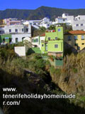 Cliff houses above deep gorge Barranco Palo Blanco by  Calle Los Barros Tenerife North.