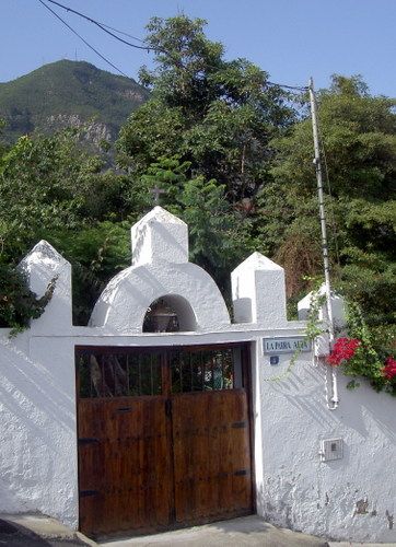 La Parra Alta Portal with its unique bell gable of the conqueror's estate by the town square Plaza San Sebastian.