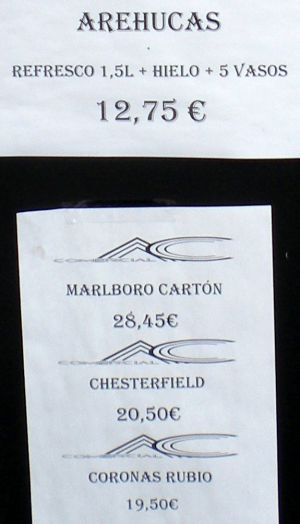 Liquor shop specials on billboard of shop named Estanco