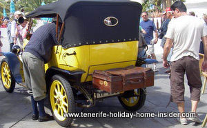 Olden day fiat with carnival driver in knickerbockers