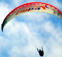 A paraglider approaches the Martianez Bay